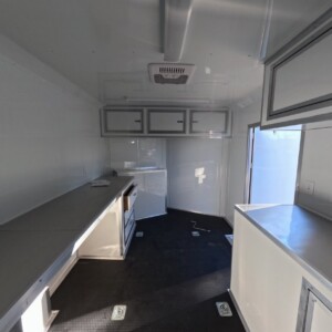 8.5x16 White Catering Trailer with mill finish counter, overhead cabinets, and generator compartment for sale.